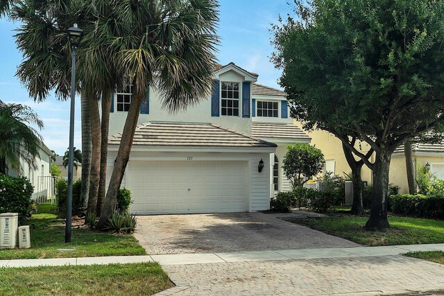 123 Canterbury Pl, Royal Palm Beach, FL 33414 - view of front facade featuring decorative driveway, a garage, and stucco siding