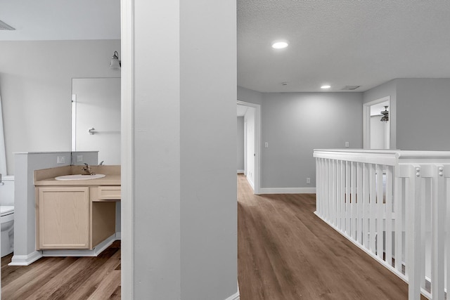123 Canterbury Pl, Royal Palm Beach, FL 33414 - hallway featuring a sink, wood finished floors, baseboards, and recessed lighting