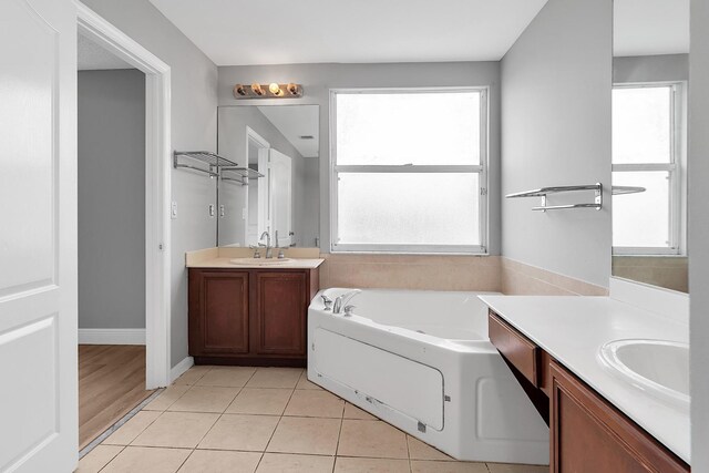 123 Canterbury Pl, Royal Palm Beach, FL 33414 - full bathroom with two vanities, a garden tub, and tile patterned floors