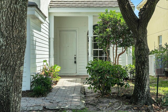 123 Canterbury Pl, Royal Palm Beach, FL 33414 - view of exterior entry with roof with shingles