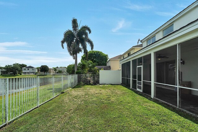 123 Canterbury Pl, Royal Palm Beach, FL 33414 - view of yard with a sunroom, a water view, a ceiling fan, and a residential view