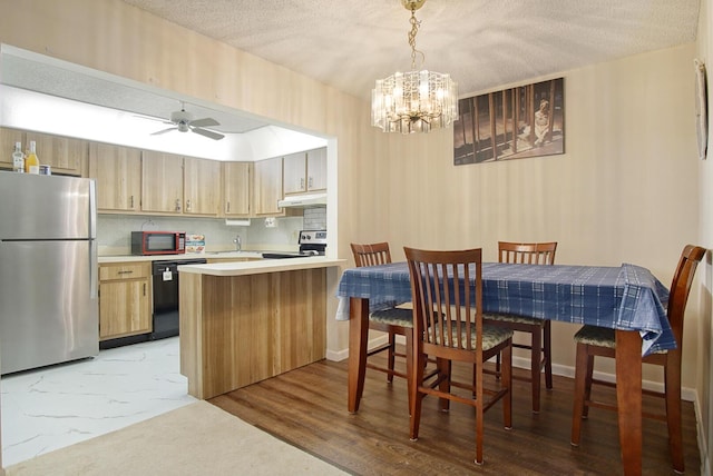 5930 Whispering Pines Way Unit C-2, Greenacres, FL 33463 - dining room with a chandelier, a textured ceiling, and a ceiling fan