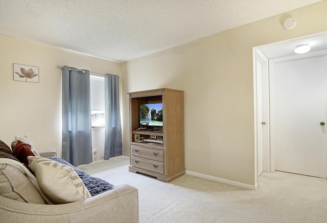 5930 Whispering Pines Way Unit C-2, Greenacres, FL 33463 - living room featuring light colored carpet, a textured ceiling, and baseboards