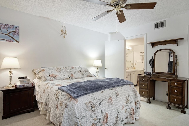 5930 Whispering Pines Way Unit C-2, Greenacres, FL 33463 - bedroom with light colored carpet, a textured ceiling, ensuite bathroom, ceiling fan, and a sink