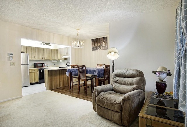 5930 Whispering Pines Way Unit C-2, Greenacres, FL 33463 - living area featuring light carpet, a chandelier, a textured ceiling, and baseboards