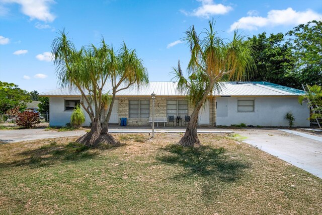 11331 SE Gold Ave, Hobe Sound, FL 33455 - single story home featuring a front yard, stucco siding, and a porch