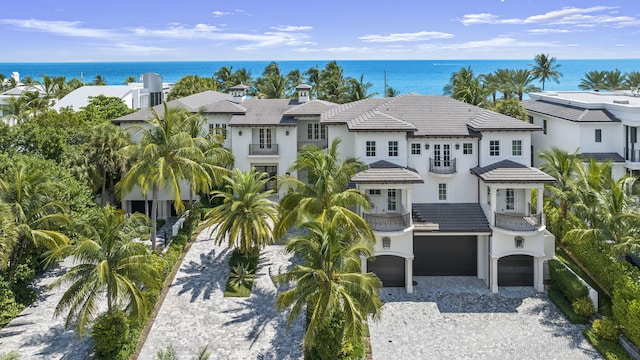526 N Ocean Blvd, Delray Beach, FL 33483 - view of front of house with a balcony, an attached garage, a water view, and decorative driveway