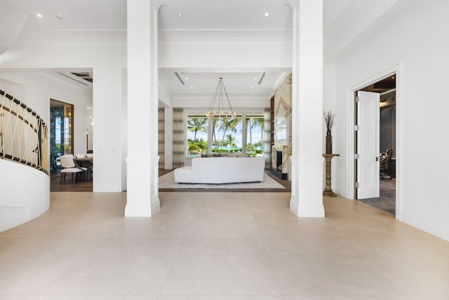 526 N Ocean Blvd, Delray Beach, FL 33483 - foyer with ornate columns, ornamental molding, healthy amount of natural light, a chandelier, and baseboards