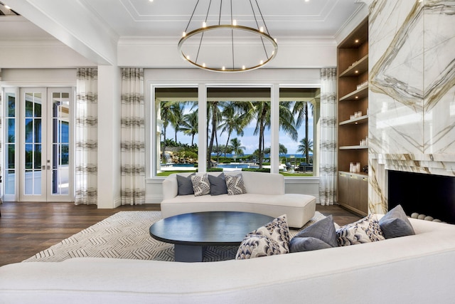 526 N Ocean Blvd, Delray Beach, FL 33483 - living area with wood finished floors, french doors, a chandelier, a high end fireplace, and crown molding