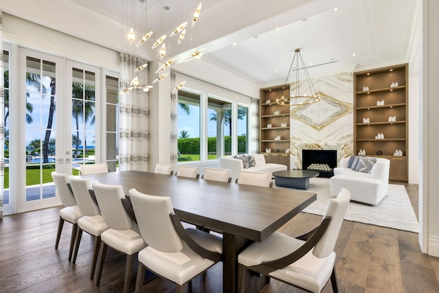 526 N Ocean Blvd, Delray Beach, FL 33483 - dining area with crown molding, french doors, built in shelves, healthy amount of natural light, and a chandelier