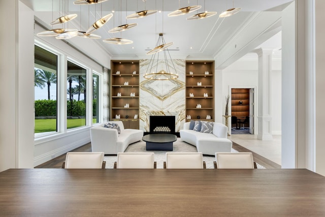 526 N Ocean Blvd, Delray Beach, FL 33483 - living area featuring ornamental molding, decorative columns, built in features, a high end fireplace, and baseboards