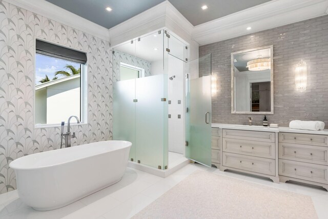 526 N Ocean Blvd, Delray Beach, FL 33483 - bathroom featuring a shower stall, crown molding, a freestanding bath, vanity, and tile patterned flooring