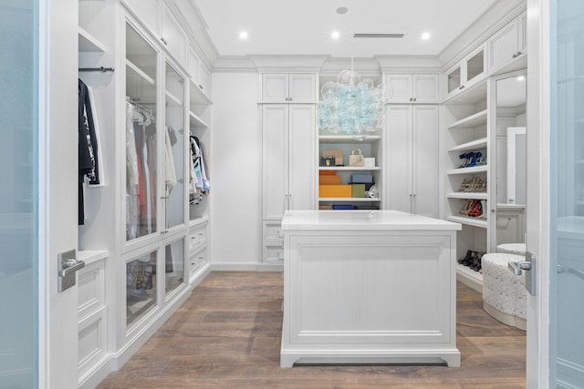 526 N Ocean Blvd, Delray Beach, FL 33483 - walk in closet with dark wood finished floors and a chandelier