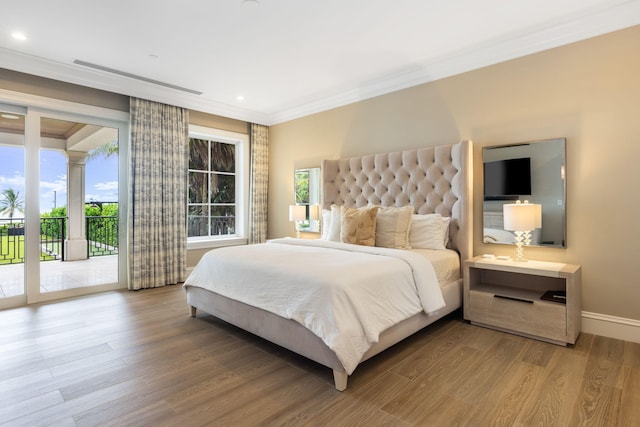 526 N Ocean Blvd, Delray Beach, FL 33483 - bedroom with access to exterior, wood finished floors, crown molding, multiple windows, and baseboards
