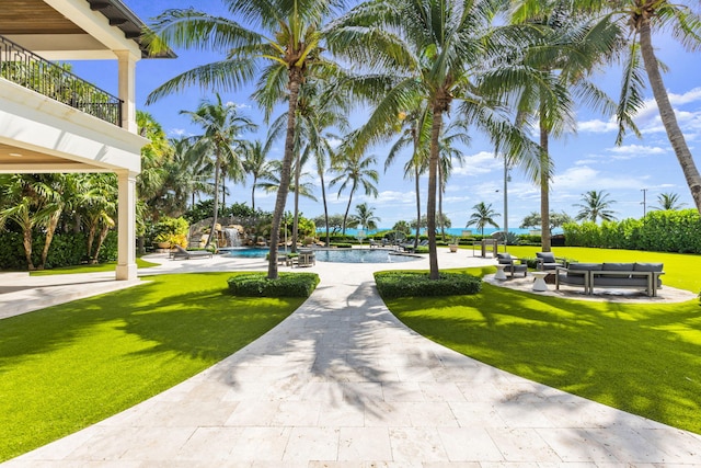 526 N Ocean Blvd, Delray Beach, FL 33483 - view of community featuring a pool, a yard, a patio area, and an outdoor hangout area