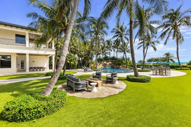526 N Ocean Blvd, Delray Beach, FL 33483 - view of green lawn with a balcony, a patio, and an outdoor pool