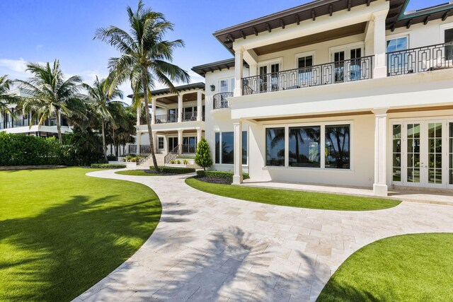 526 N Ocean Blvd, Delray Beach, FL 33483 - back of house with french doors, stucco siding, and a yard