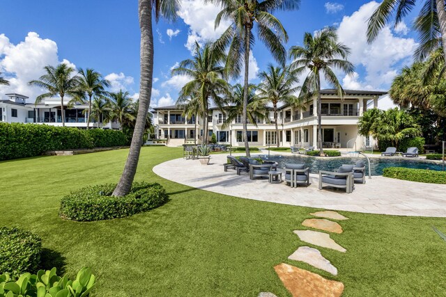 526 N Ocean Blvd, Delray Beach, FL 33483 - view of property's community featuring a patio area, a lawn, and a pool