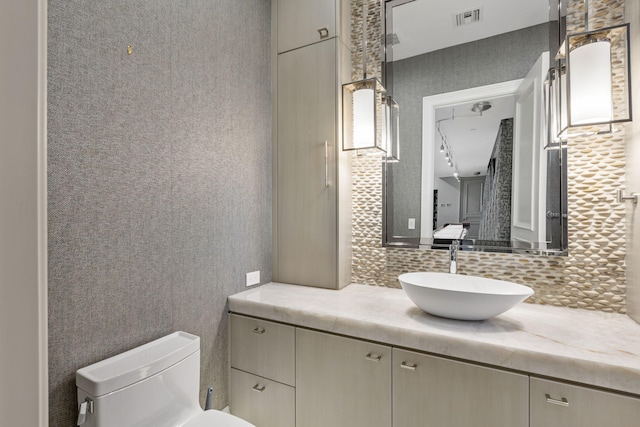 526 N Ocean Blvd, Delray Beach, FL 33483 - bathroom with vanity, decorative backsplash, and toilet