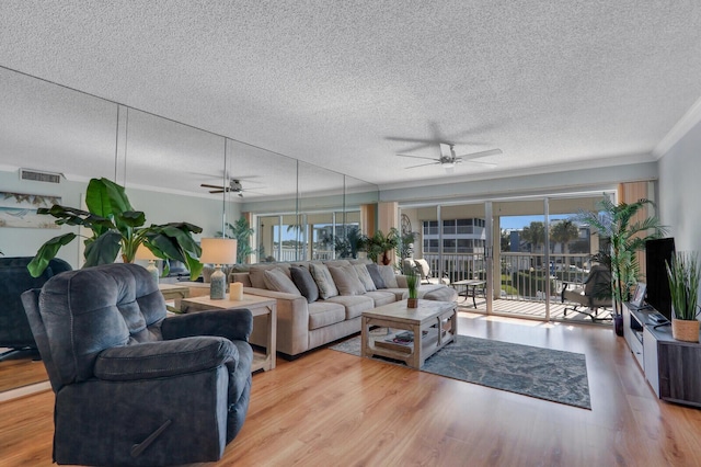 1858 SW Palm City Rd Unit 205, Stuart, FL 34994 - living area featuring ceiling fan, crown molding, a textured ceiling, and wood finished floors