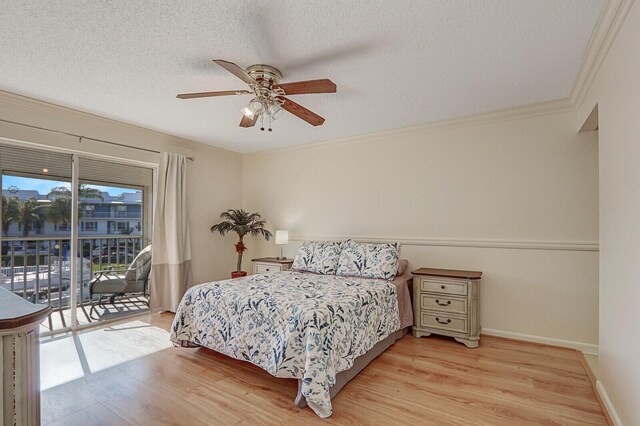 1858 SW Palm City Rd Unit 205, Stuart, FL 34994 - bedroom with access to outside, light wood-style flooring, a textured ceiling, a ceiling fan, and ornamental molding
