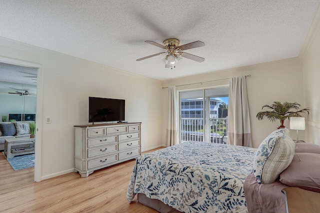 1858 SW Palm City Rd Unit 205, Stuart, FL 34994 - bedroom with light wood finished floors, a textured ceiling, access to outside, baseboards, and ceiling fan