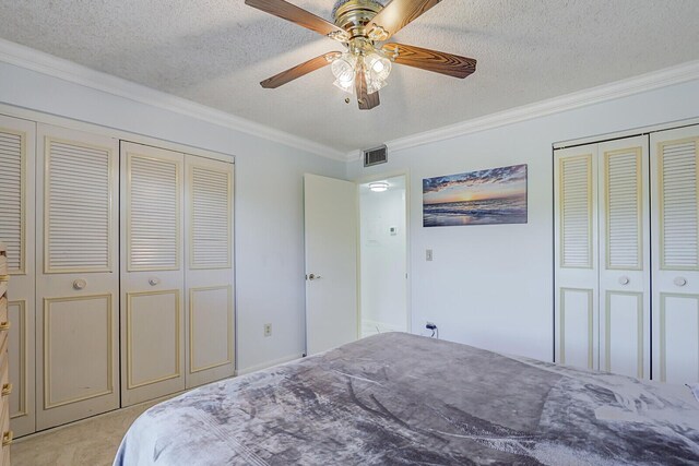 1858 SW Palm City Rd Unit 205, Stuart, FL 34994 - bedroom featuring crown molding, a textured ceiling, light carpet, and a ceiling fan