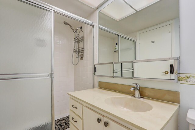 1858 SW Palm City Rd Unit 205, Stuart, FL 34994 - bathroom with a shower stall, vanity, and toilet