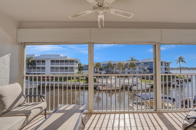 1858 SW Palm City Rd Unit 205, Stuart, FL 34994 - unfurnished sunroom with a ceiling fan, a water view, and a residential view