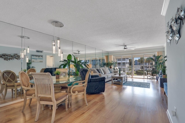 1858 SW Palm City Rd Unit 205, Stuart, FL 34994 - dining space with a ceiling fan, a textured ceiling, and wood finished floors