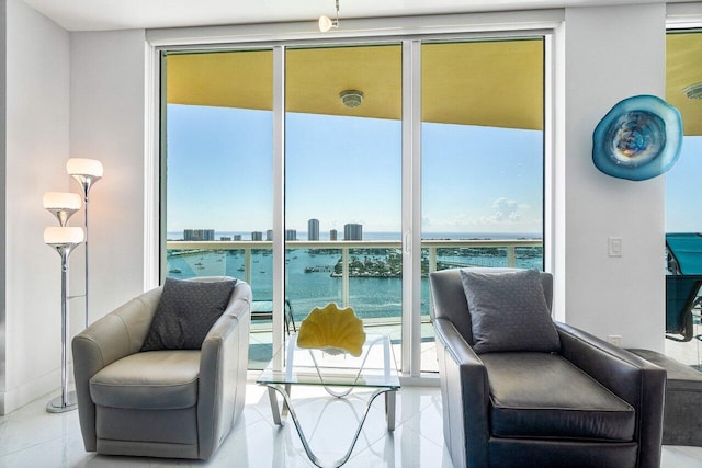 2640 Lake Shore Dr Unit 2307, Riviera Beach, FL 33404 - sitting room featuring floor to ceiling windows, a water view, and tile patterned flooring