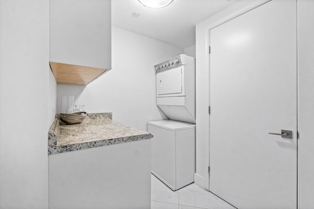 2640 Lake Shore Dr Unit 2307, Riviera Beach, FL 33404 - laundry area with stacked washer and clothes dryer and light marble finish flooring