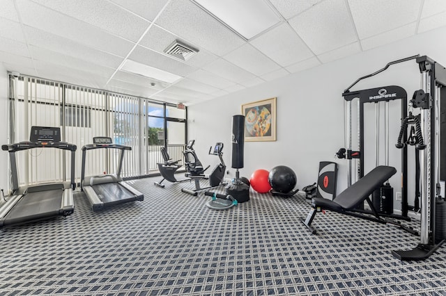 2000 Presidential Way Unit 205, West Palm Beach, FL 33401 - exercise room with a paneled ceiling, expansive windows, carpet flooring, and baseboards