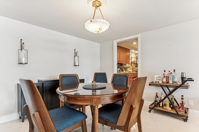 2000 Presidential Way Unit 205, West Palm Beach, FL 33401 - dining space with light tile patterned floors and baseboards