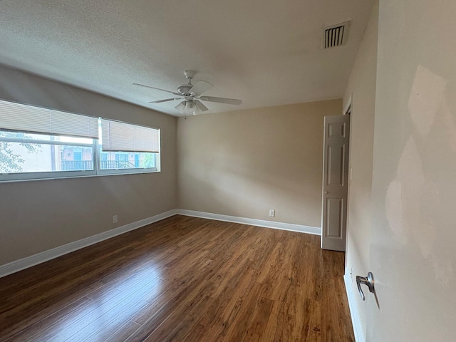 118 Yacht Club Dr Unit 7, North Palm Beach, FL 33408 - spare room featuring dark wood-style flooring, a ceiling fan, and baseboards