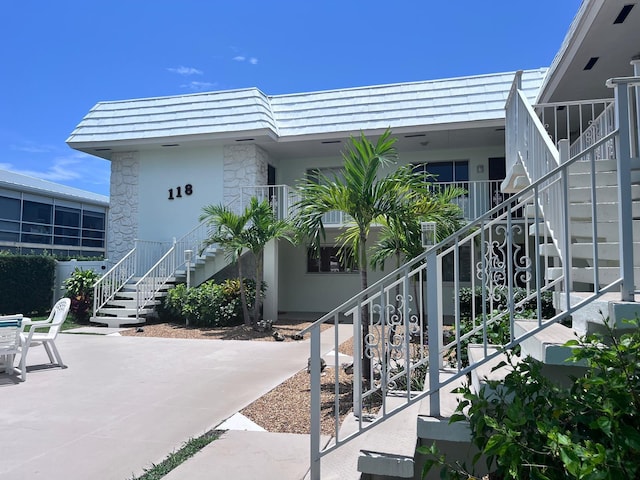 118 Yacht Club Dr Unit 7, North Palm Beach, FL 33408 - view of building exterior featuring stairs