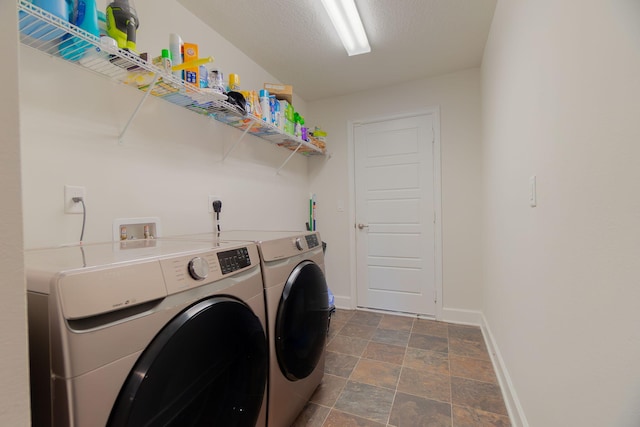 517 SW Cherryhill Rd, Port Saint Lucie, FL 34953 - laundry area with washer and clothes dryer and stone finish floors