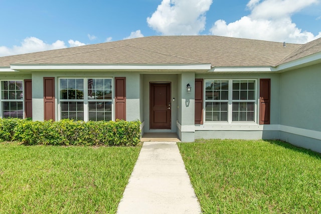 517 SW Cherryhill Rd, Port Saint Lucie, FL 34953 - entrance to property with a lawn, stucco siding, and a shingled roof