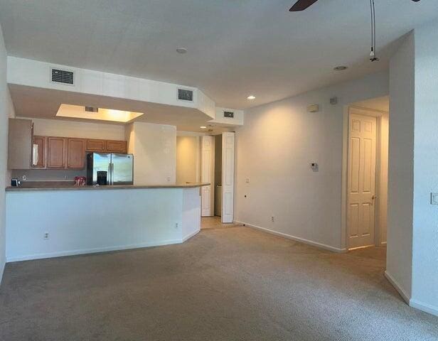 10280 SW Stephanie Way Unit 8209, Port Saint Lucie, FL 34987 - unfurnished living room featuring light colored carpet, baseboards, ceiling fan, and recessed lighting
