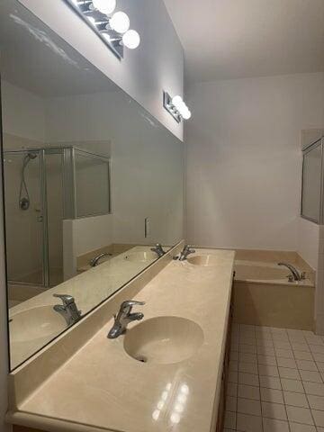 10280 SW Stephanie Way Unit 8209, Port Saint Lucie, FL 34987 - bathroom featuring a bath, tile patterned floors, a stall shower, and double vanity