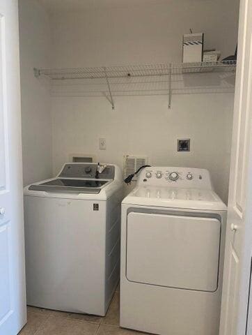 10280 SW Stephanie Way Unit 8209, Port Saint Lucie, FL 34987 - laundry area featuring washer and dryer and light tile patterned flooring