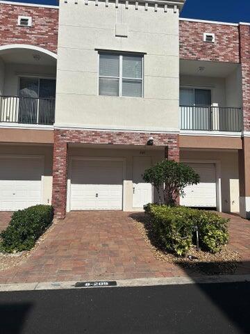 10280 SW Stephanie Way Unit 8209, Port Saint Lucie, FL 34987 - view of building exterior with a garage and driveway