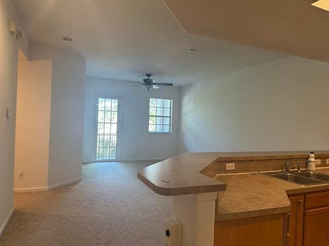 10280 SW Stephanie Way Unit 8209, Port Saint Lucie, FL 34987 - kitchen with a sink, baseboards, light carpet, and ceiling fan