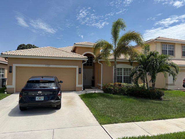 7727 Colony Lake Dr, Boynton Beach, FL 33436 - mediterranean / spanish-style home with driveway, stucco siding, a garage, and a front lawn