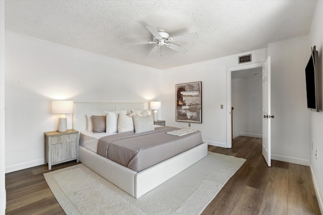 744 Buttonwood Ln Unit 411-D, Boynton Beach, FL 33436 - bedroom featuring wood finished floors, a textured ceiling, baseboards, and a ceiling fan