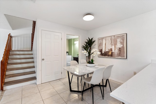 744 Buttonwood Ln Unit 411-D, Boynton Beach, FL 33436 - dining room featuring stairway, light tile patterned flooring, washer / dryer, and baseboards
