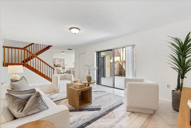 744 Buttonwood Ln Unit 411-D, Boynton Beach, FL 33436 - living room with stairs, light tile patterned floors, and a textured ceiling