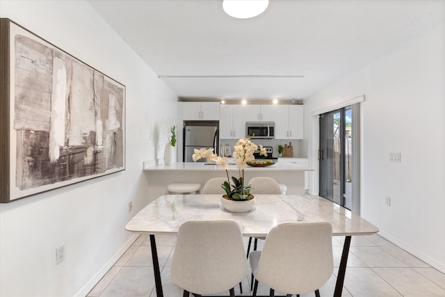 744 Buttonwood Ln Unit 411-D, Boynton Beach, FL 33436 - dining space with light tile patterned flooring and baseboards