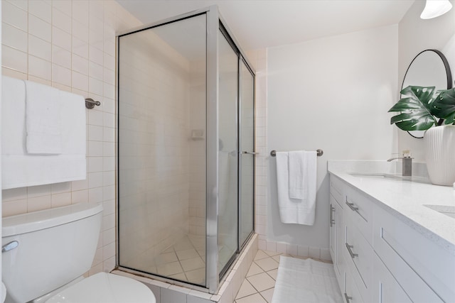 744 Buttonwood Ln Unit 411-D, Boynton Beach, FL 33436 - full bathroom with toilet, a stall shower, double vanity, and tile patterned flooring