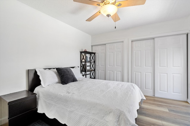744 Buttonwood Ln Unit 411-D, Boynton Beach, FL 33436 - bedroom featuring multiple closets, light wood-style flooring, and a ceiling fan